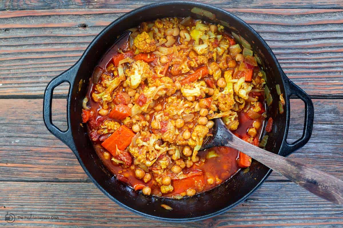 chickpeas, tomatoes, and roasted vegetables added to Dutch oven to make chickpea stew
