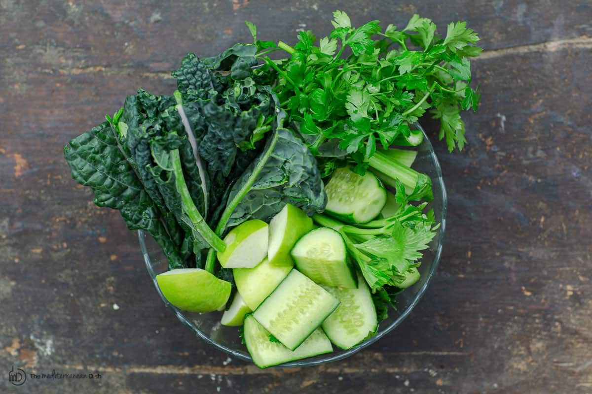 Cut vegetables and greens in a bowl