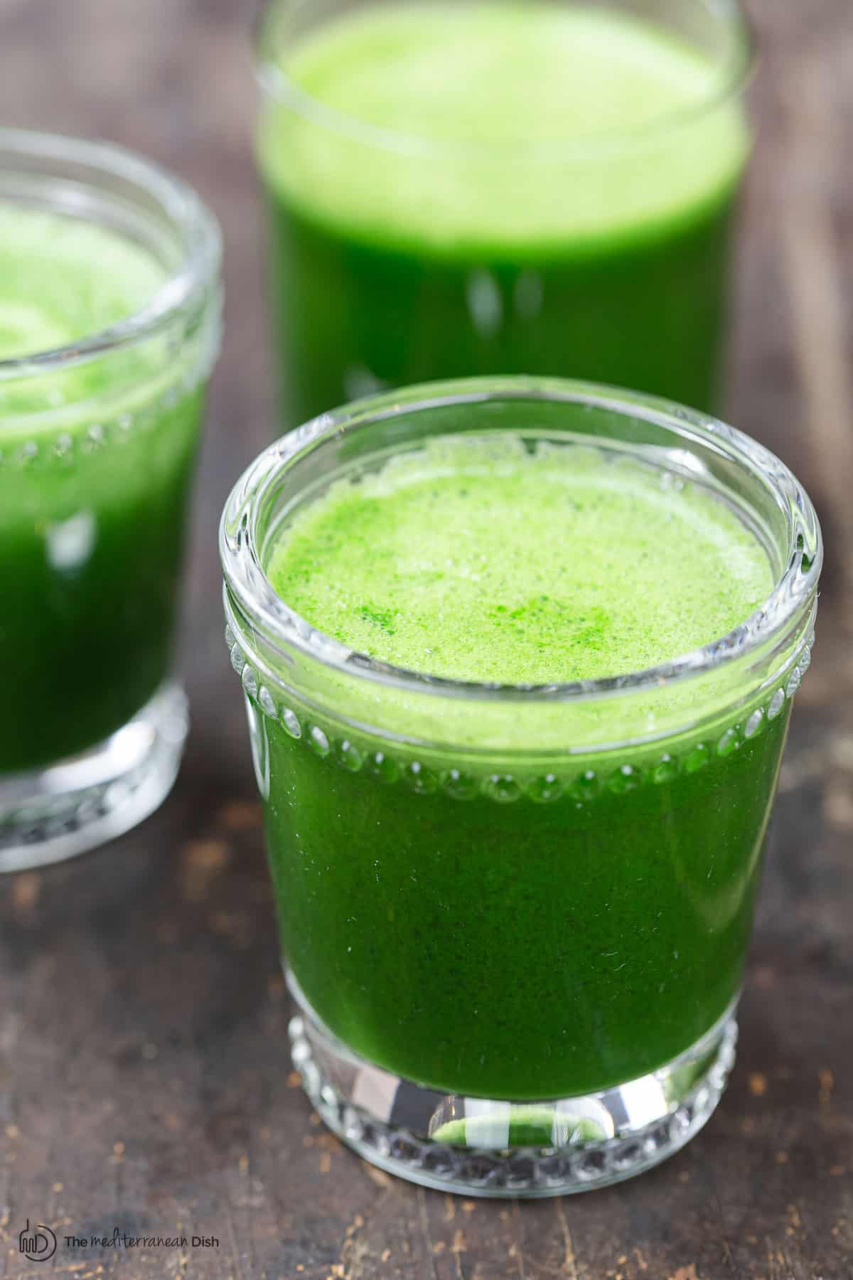 three small cups of green juice
