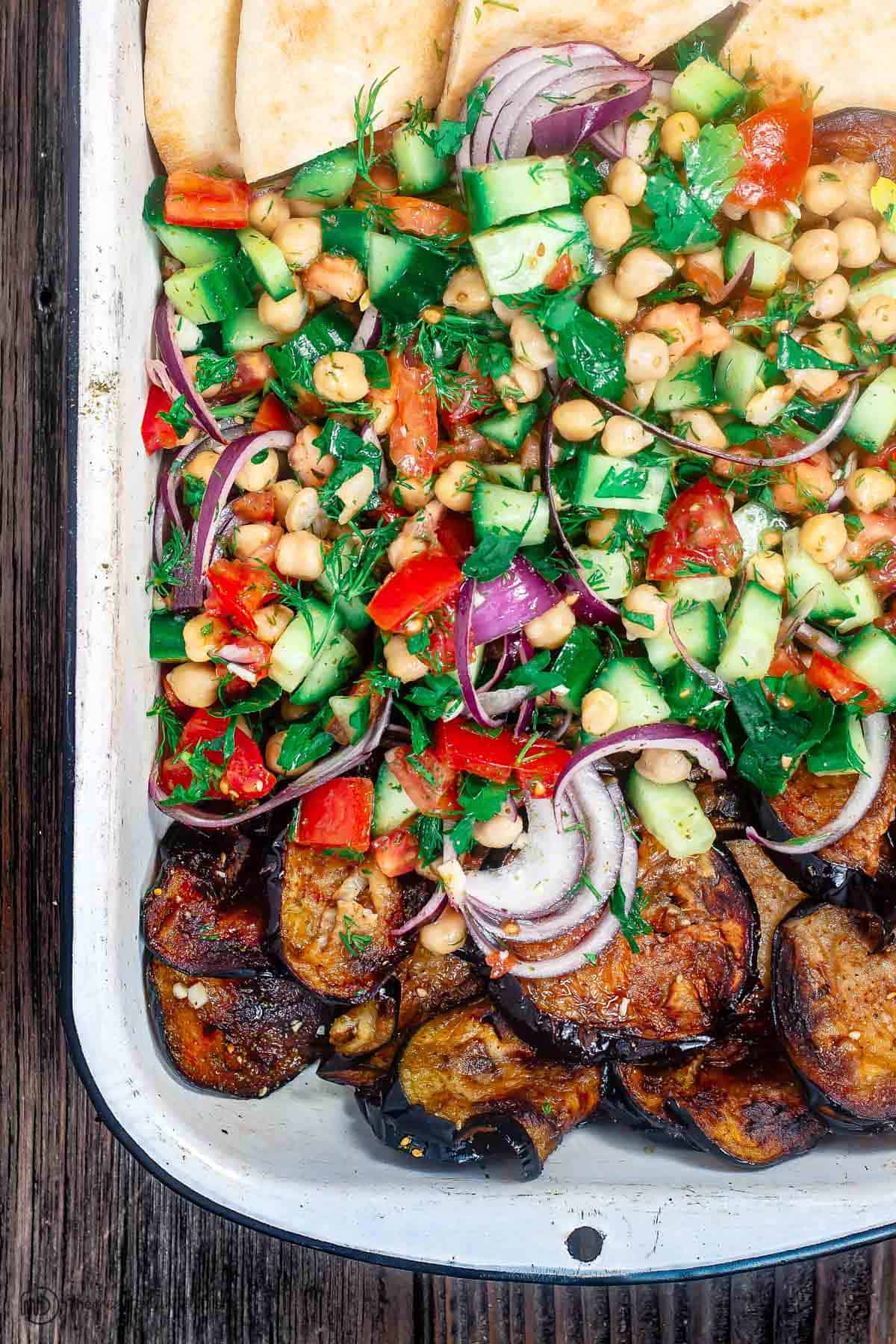 Chickpea salad assembled on platter with pita