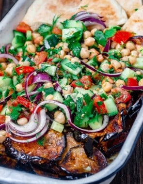 Mediterranean chickpea salad with a side of eggplant and pita