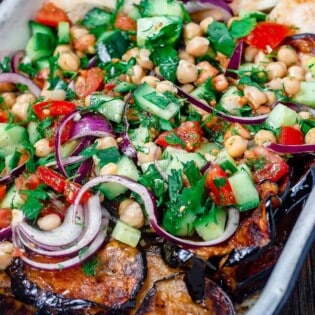 Mediterranean chickpea salad with a side of eggplant and pita