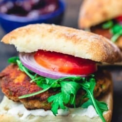 Juicy salmon burgers, served in Italian ciabatta rolls with arugula, tomatoes, and sliced onions