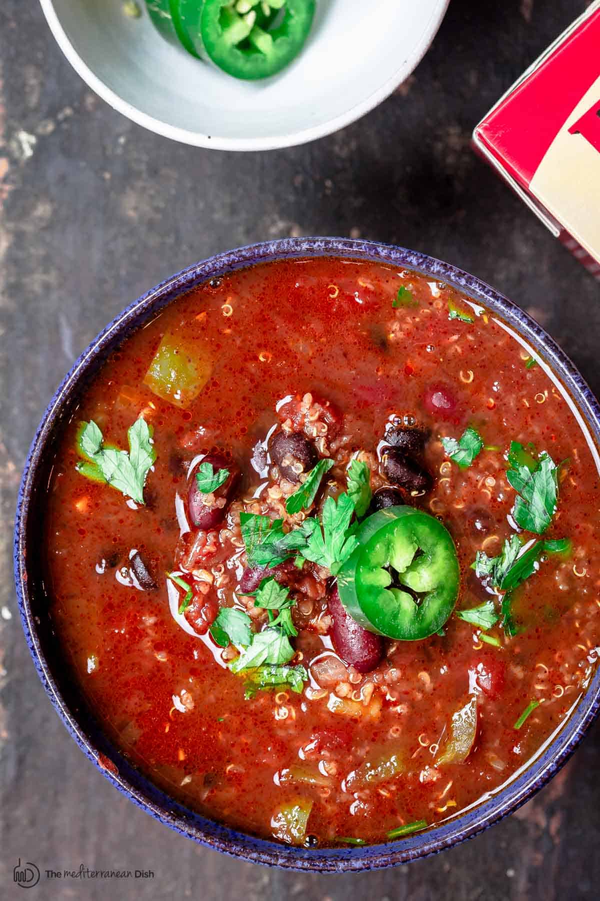 Vegan chili in a bowl with quinoa and jalapenos