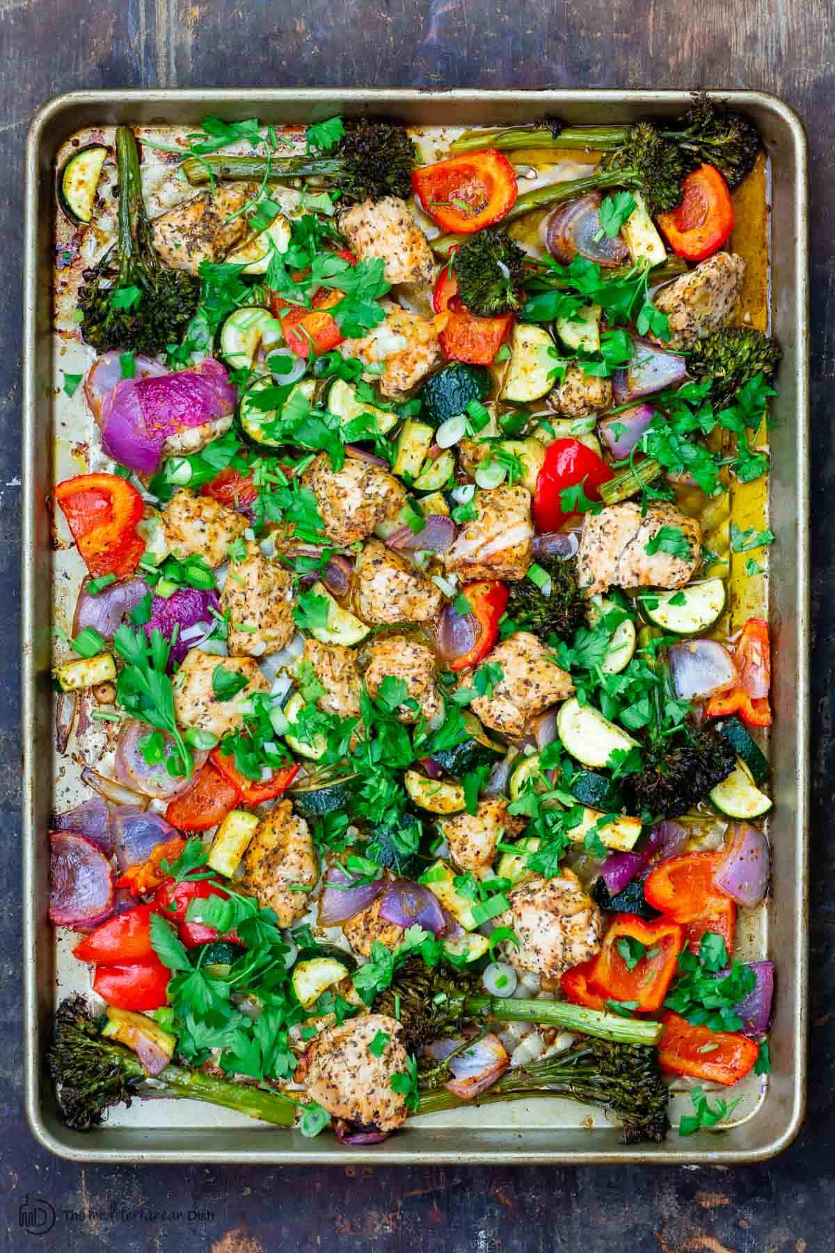 Baked chicken and vegetables on a sheet pan