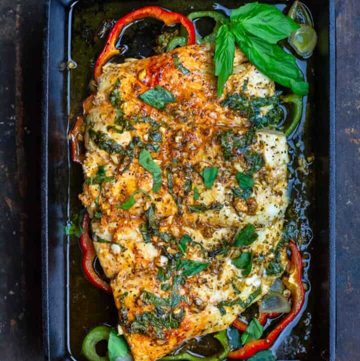 Marinated baked fish with garlic, basil, and bell peppers