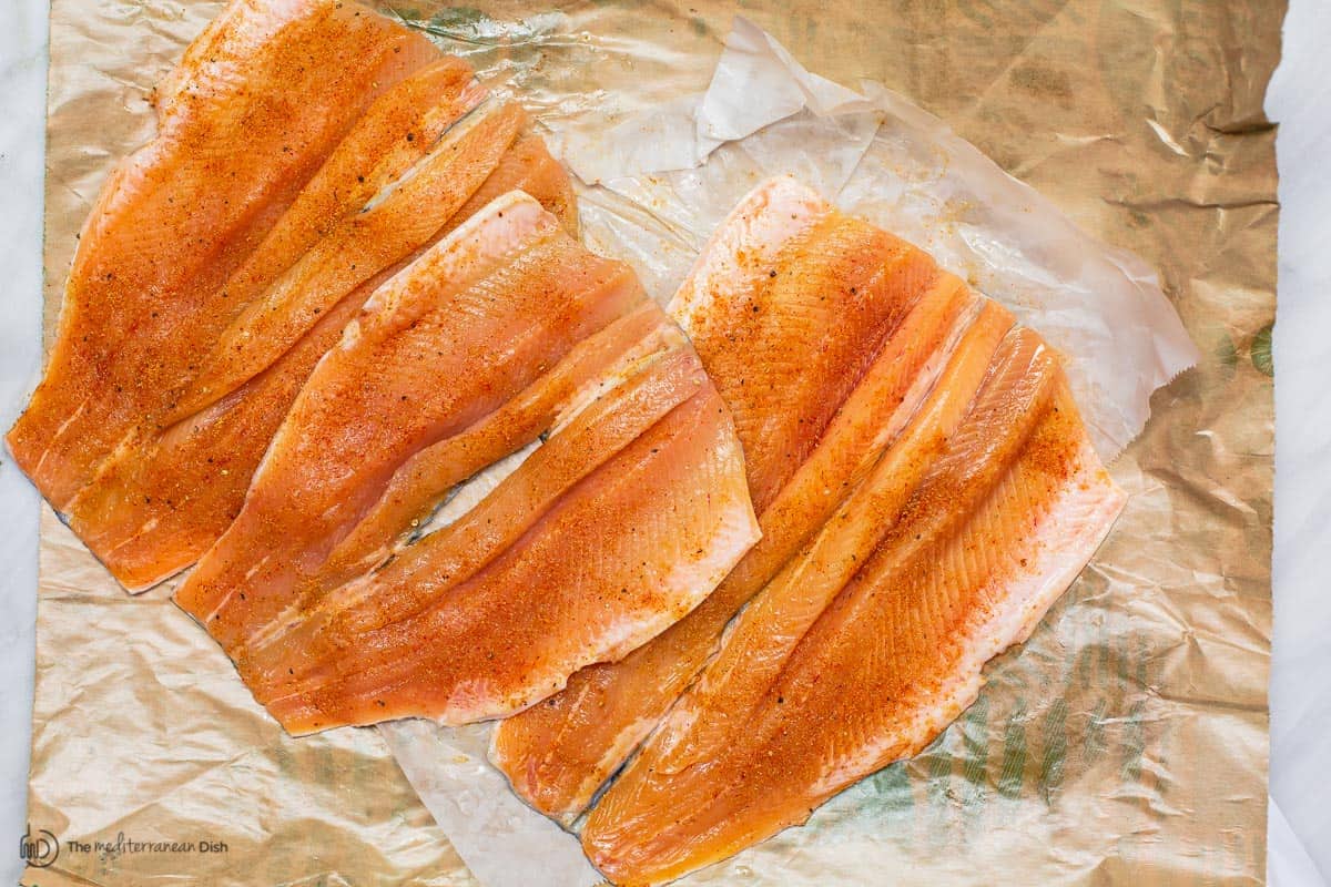 Trout fillet seasoned with spices. First step to cook trout