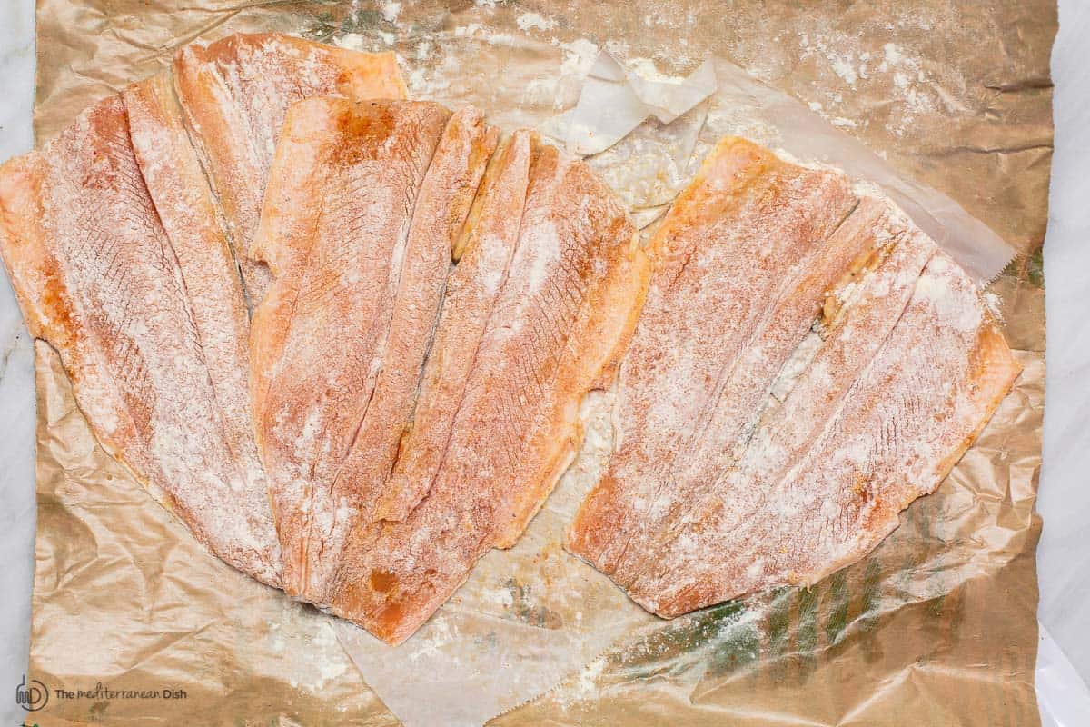 Trout is coated in a little flour before searing. Second step to cook trout