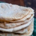 Stack of pita bread over a kitchen towel