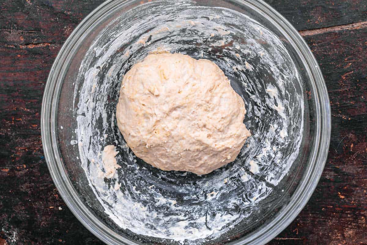 pita dough kneaded briefly in the bowl to incorporate stray pieces