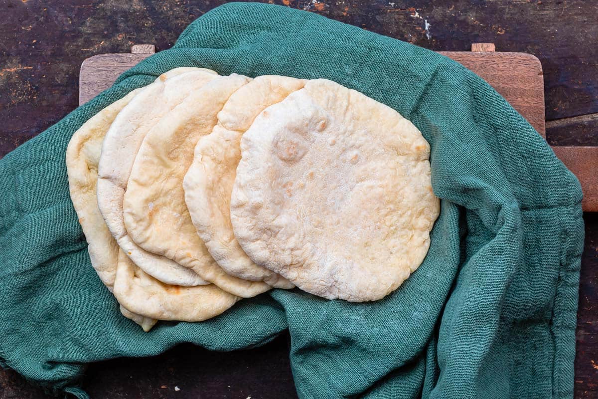 baked pita loaves on a kitchen towel 