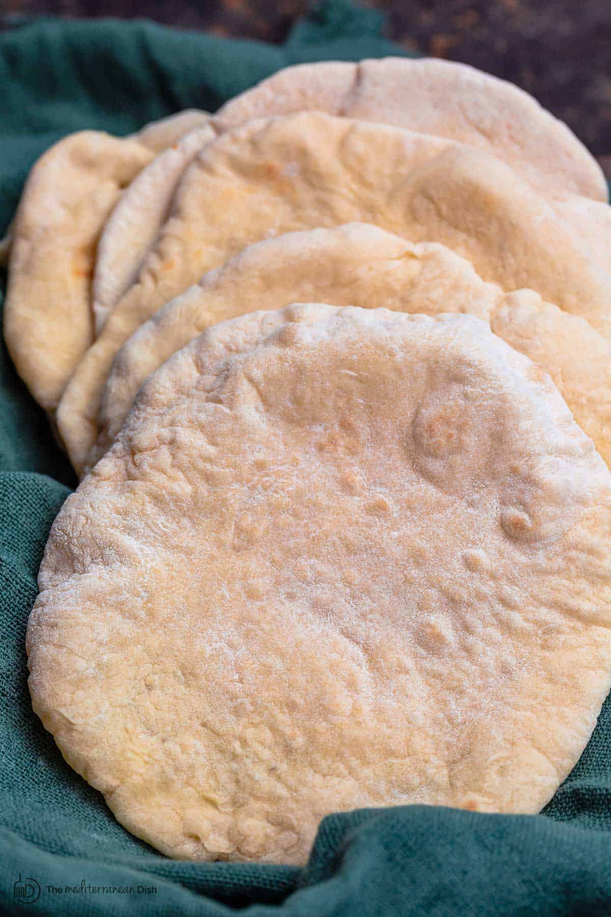 Baked pita bread in kitchen towel