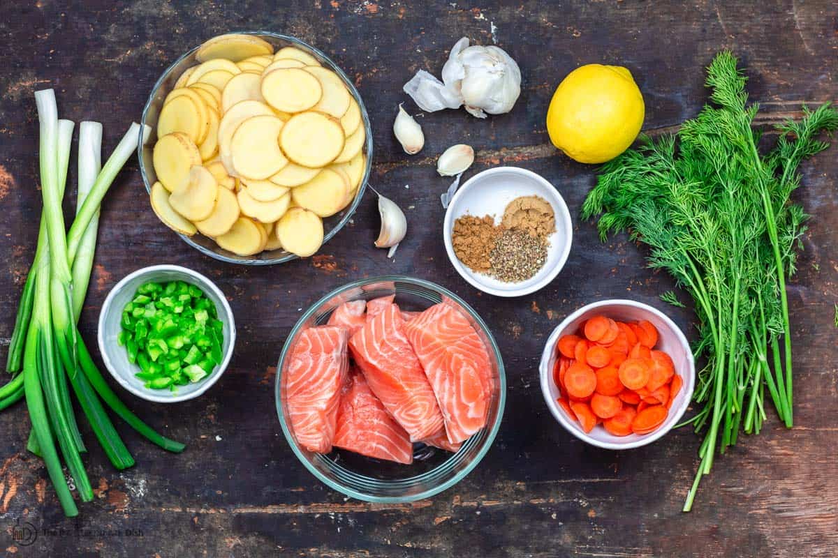 Ingredients for salmon soup. Salmon, potatoes, carrots, spices, fresh dill, green onions, lemon, garlic, bell peppers