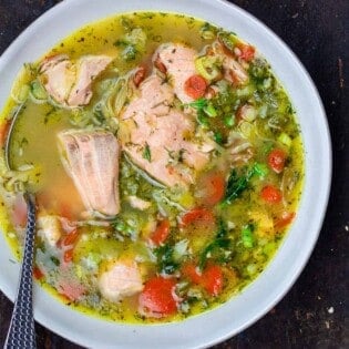 Salmon soup in a bowl. A side of bread