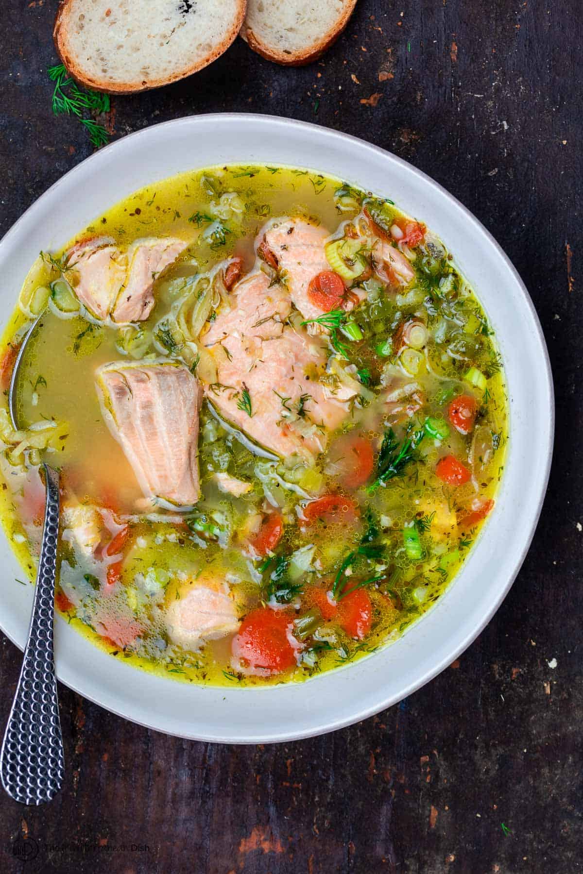 Salmon soup in a bowl. A side of bread