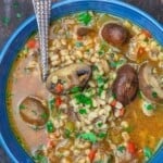 Mushroom barley soup served in a blue dinner bowl