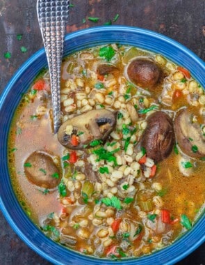 Mushroom barley soup served in a blue dinner bowl