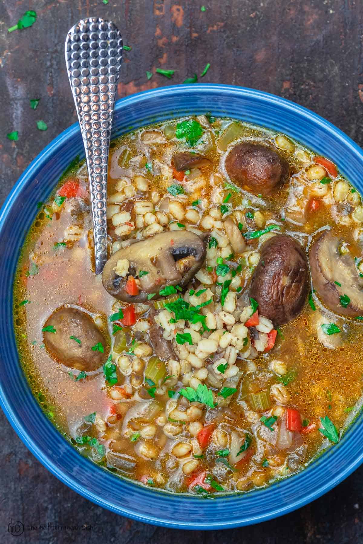 Mushroom barley soup served in a blue dinner bowl