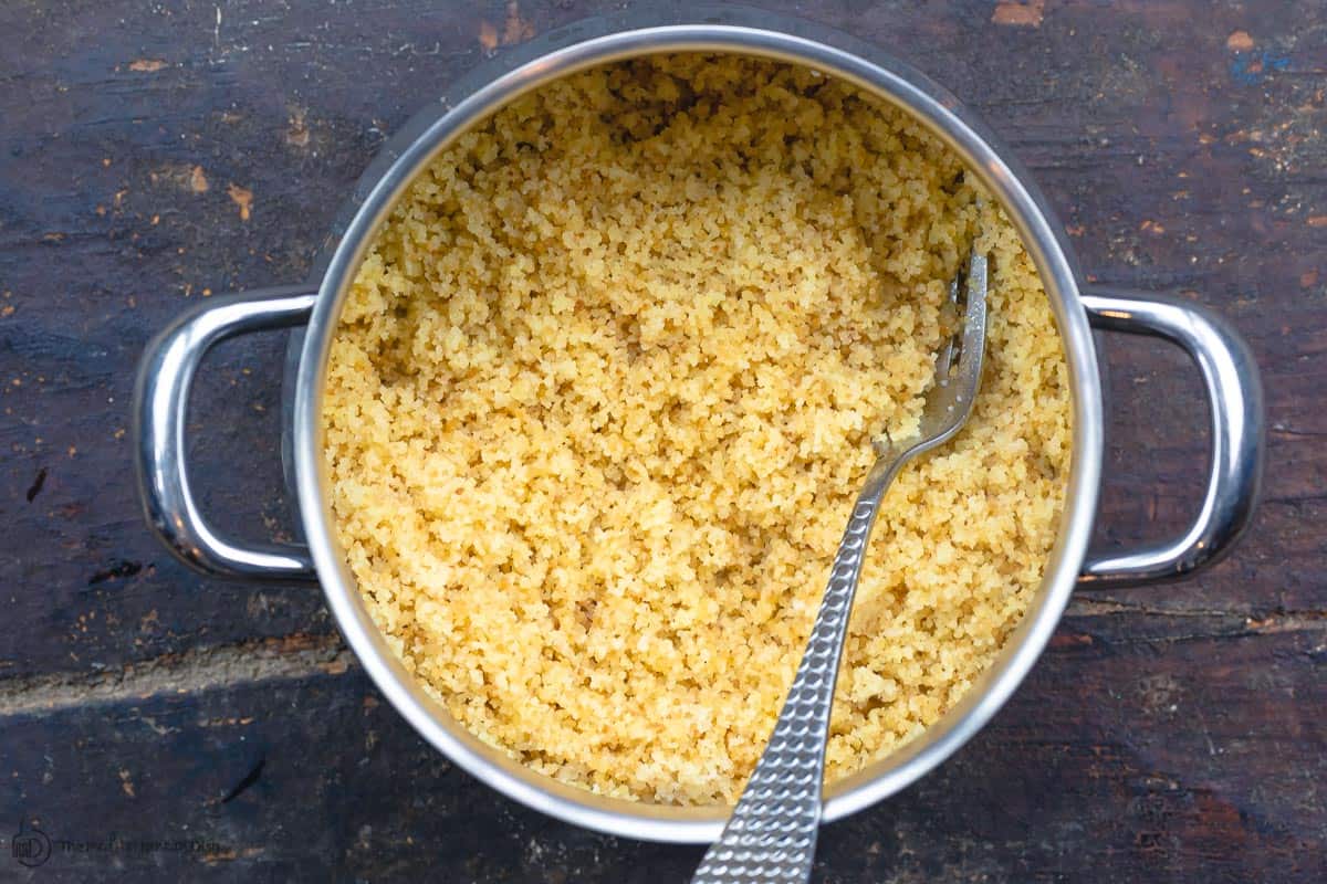 Cooked couscous in saucepan