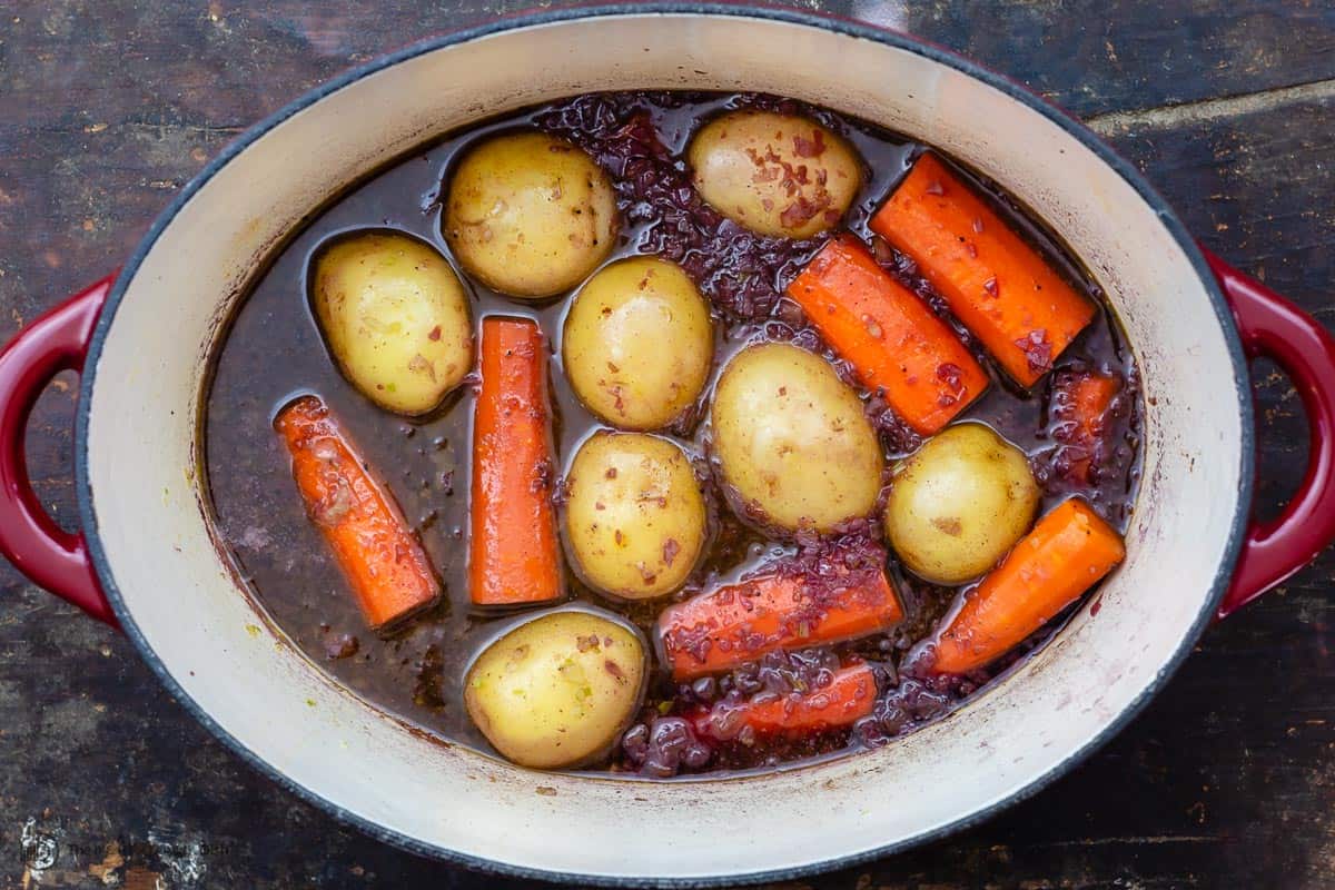 Vegetables in pot with braising liquid