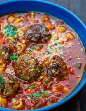 Meatball soup served in a bowl and garnished with parsley