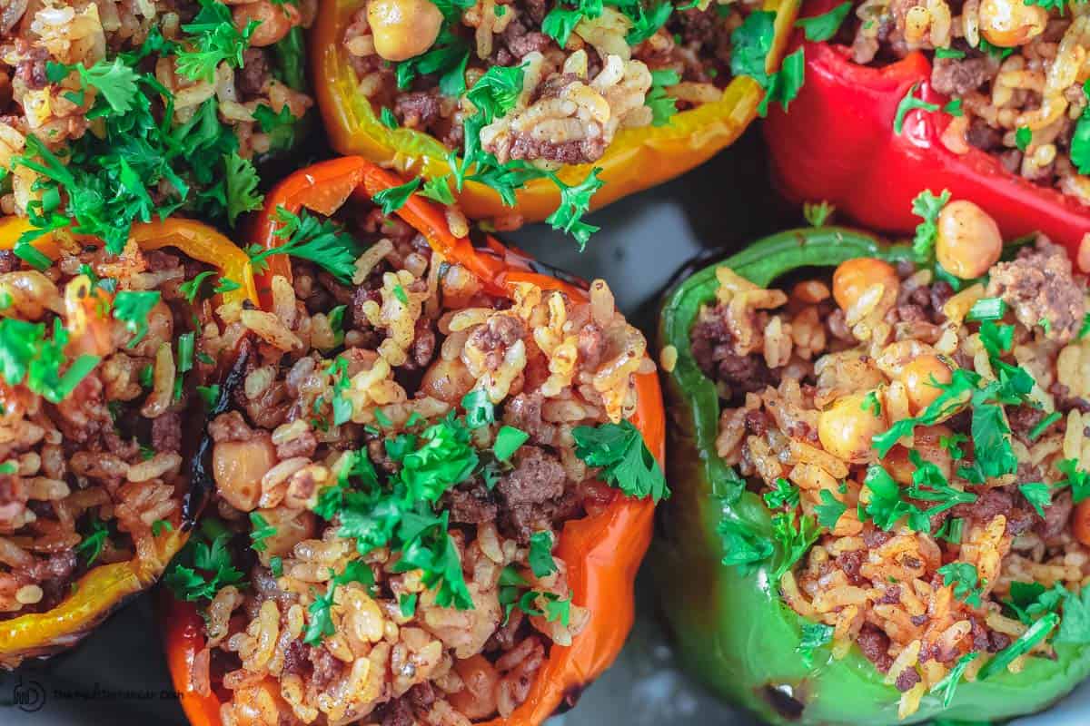 Bell peppers are assembled and stuffed with rice mixture before baking