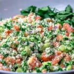 cauliflower salad in a large bowl with fresh parsley for garnish