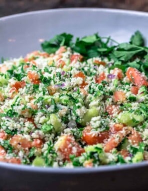 cauliflower salad in a large bowl with fresh parsley for garnish