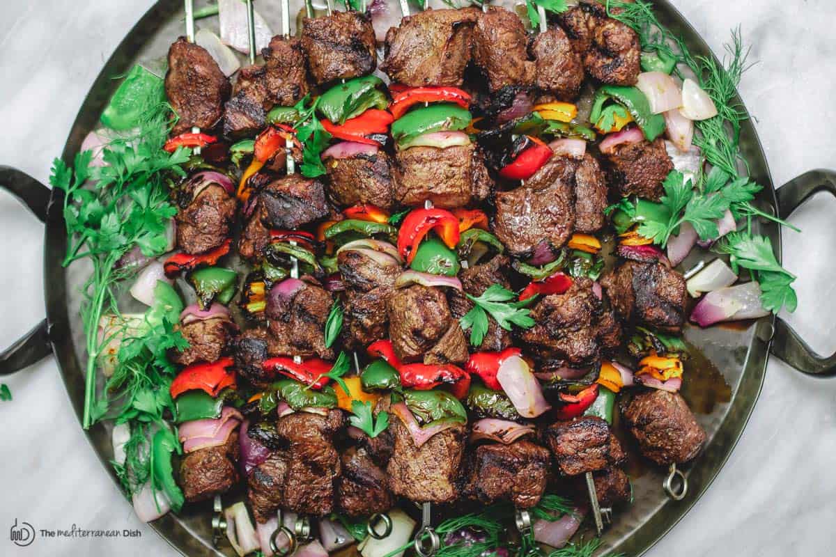 beef shish kebab on large paltter with parsley garnish