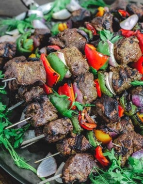 Steak kabobs with bell peppers and onions served on platter