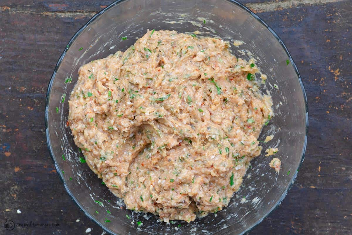 ground chicken mixed with fresh herbs and spices in a bowl