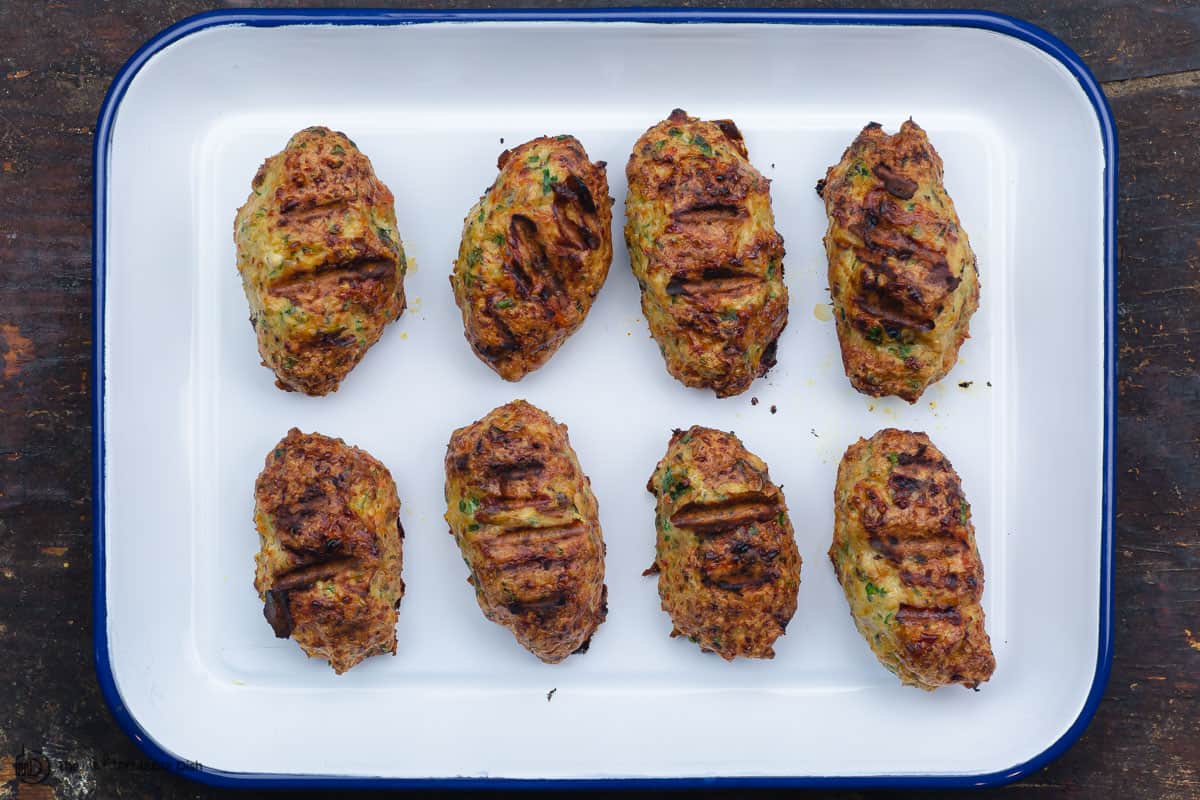 fully grilled chicken kofta patties on a tray