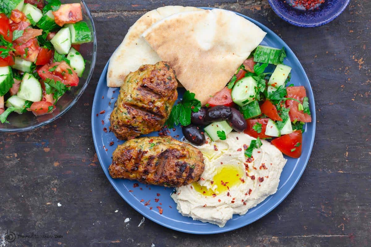 platted kofta patties with side of pita bread, hummus and salad