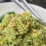 pin image with a bowl of fusilli pasta covered in broccoli pesto