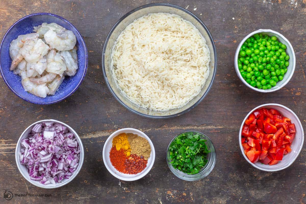 ingredients. rice, shrimp, red onions, spices, red bell peppers, peas and parsley