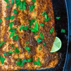 honey mustard salmon garnished with parsley and sliced lime