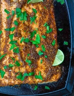 honey mustard salmon garnished with parsley and sliced lime