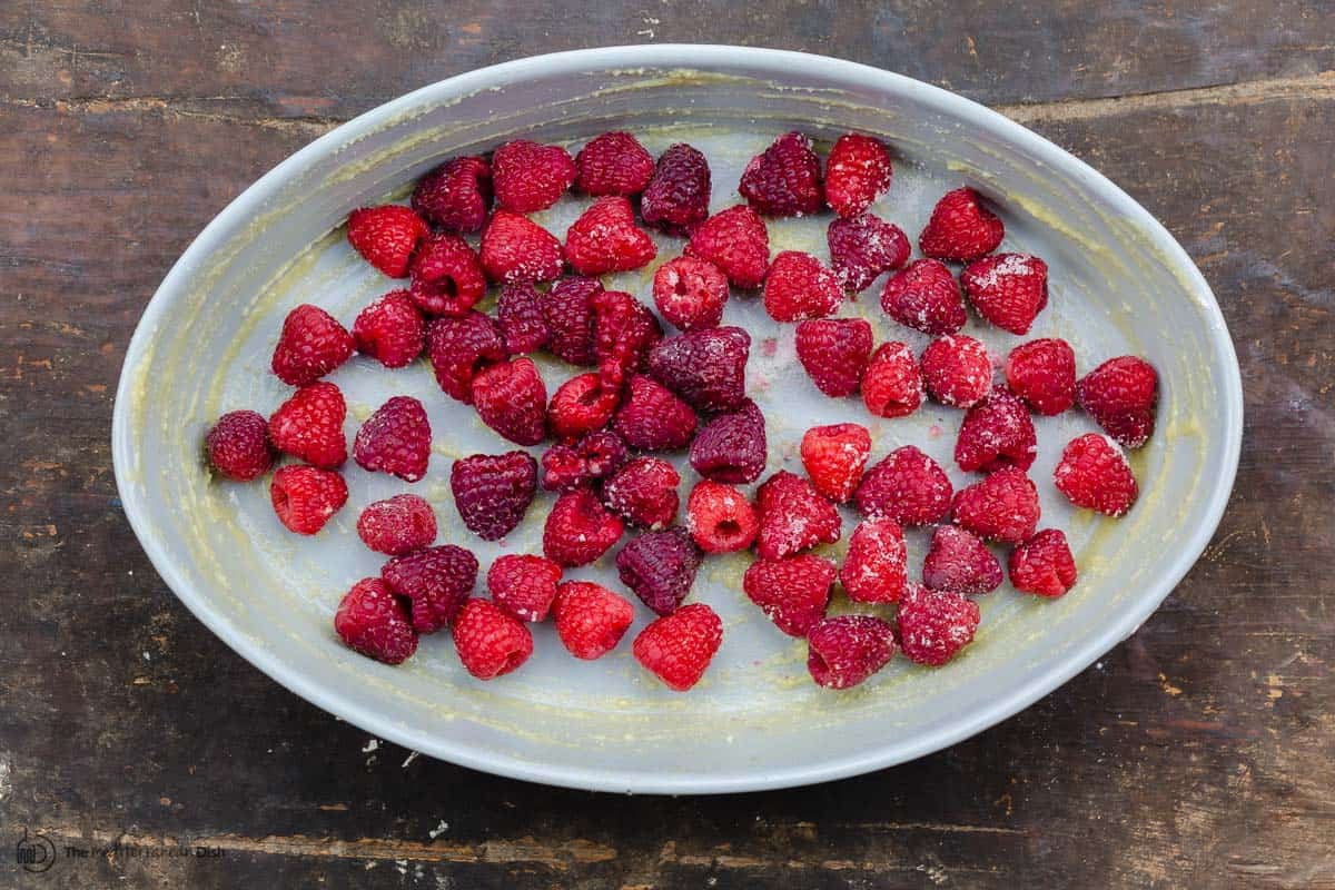 raspberries arranged in the bottom of a baking dish
