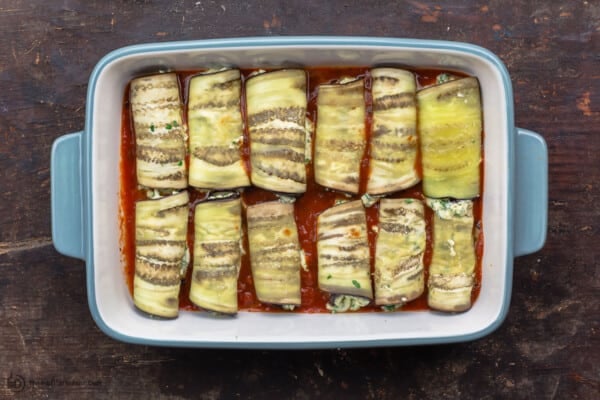 eggplant roll ups arranged in baking dish