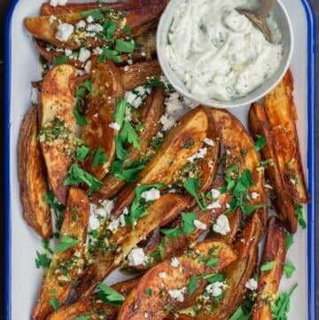 Oven fries with feta cheese and a side of tzatziki sauce