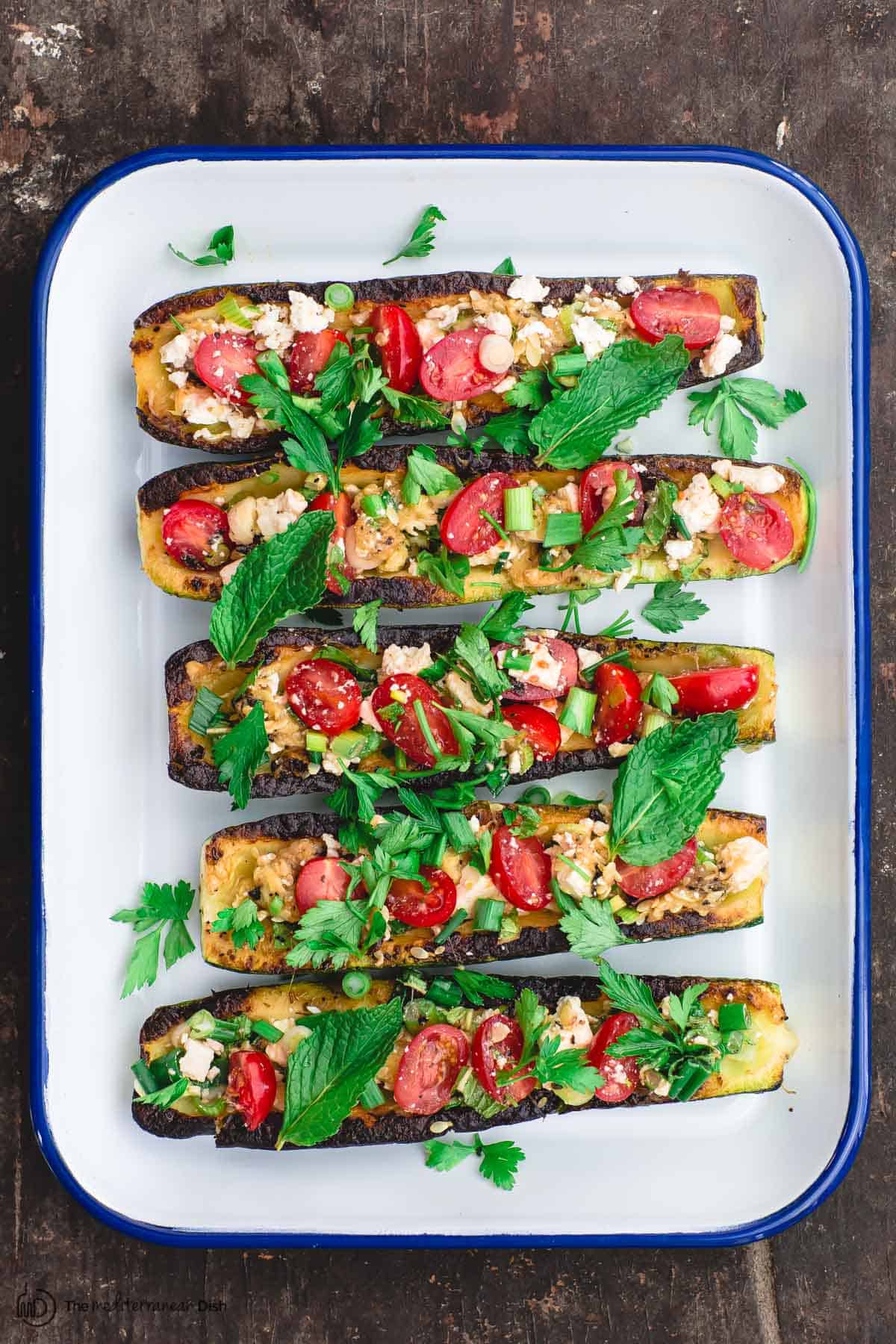 zucchini boats topped with tomatoes and feta