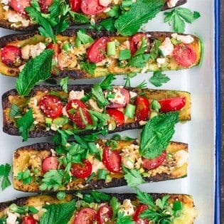 vegetarian zucchini boats assembled on serving platter