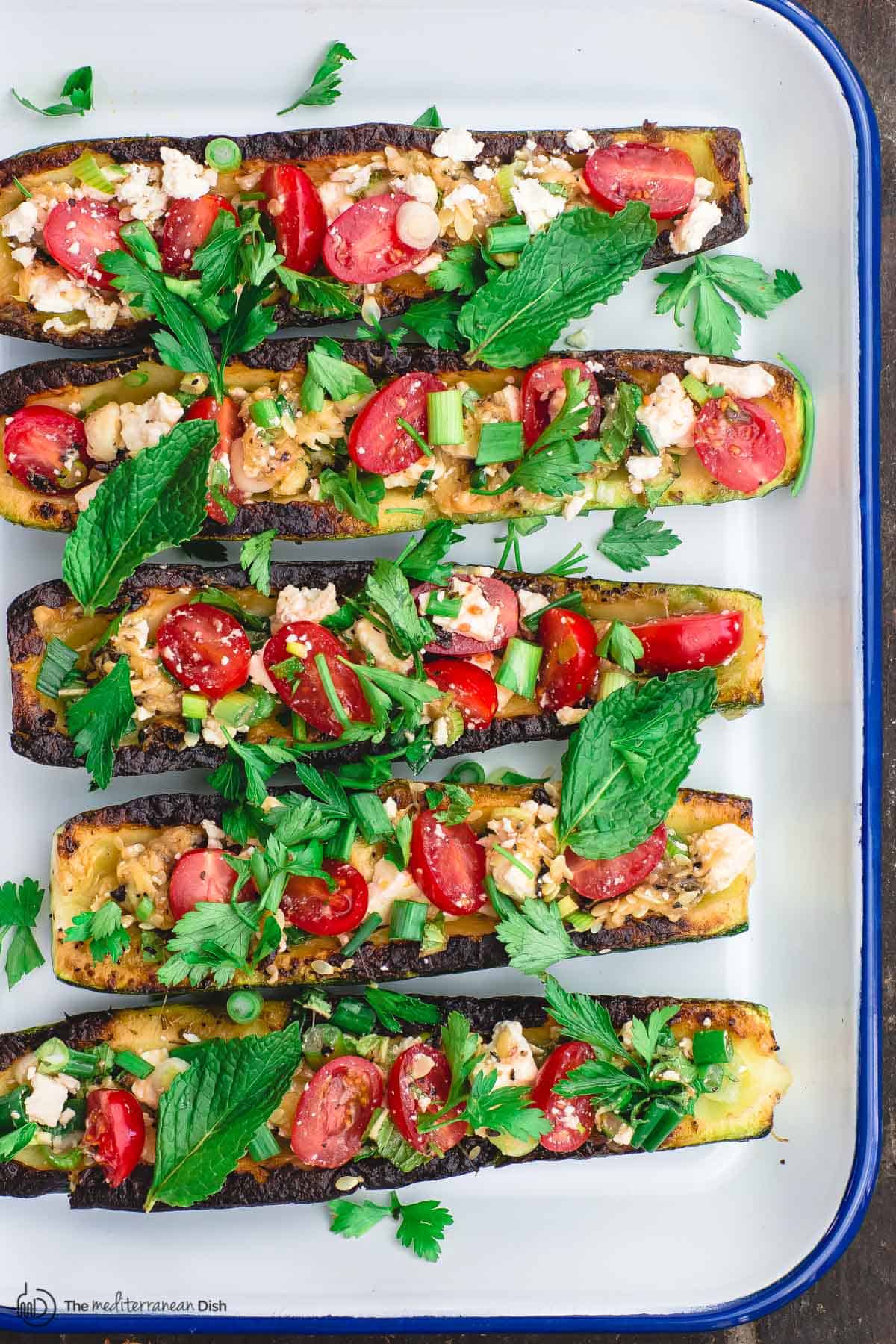 vegetarian zucchini boats assembled on serving platter