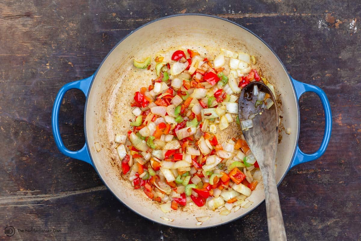 Onions, peppers, and celery cooked in skillet