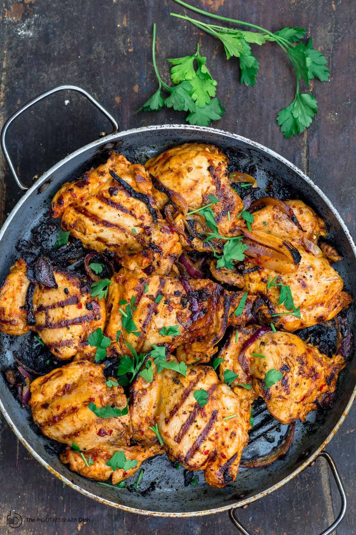 harissa chicken in the pan. a side of parsley