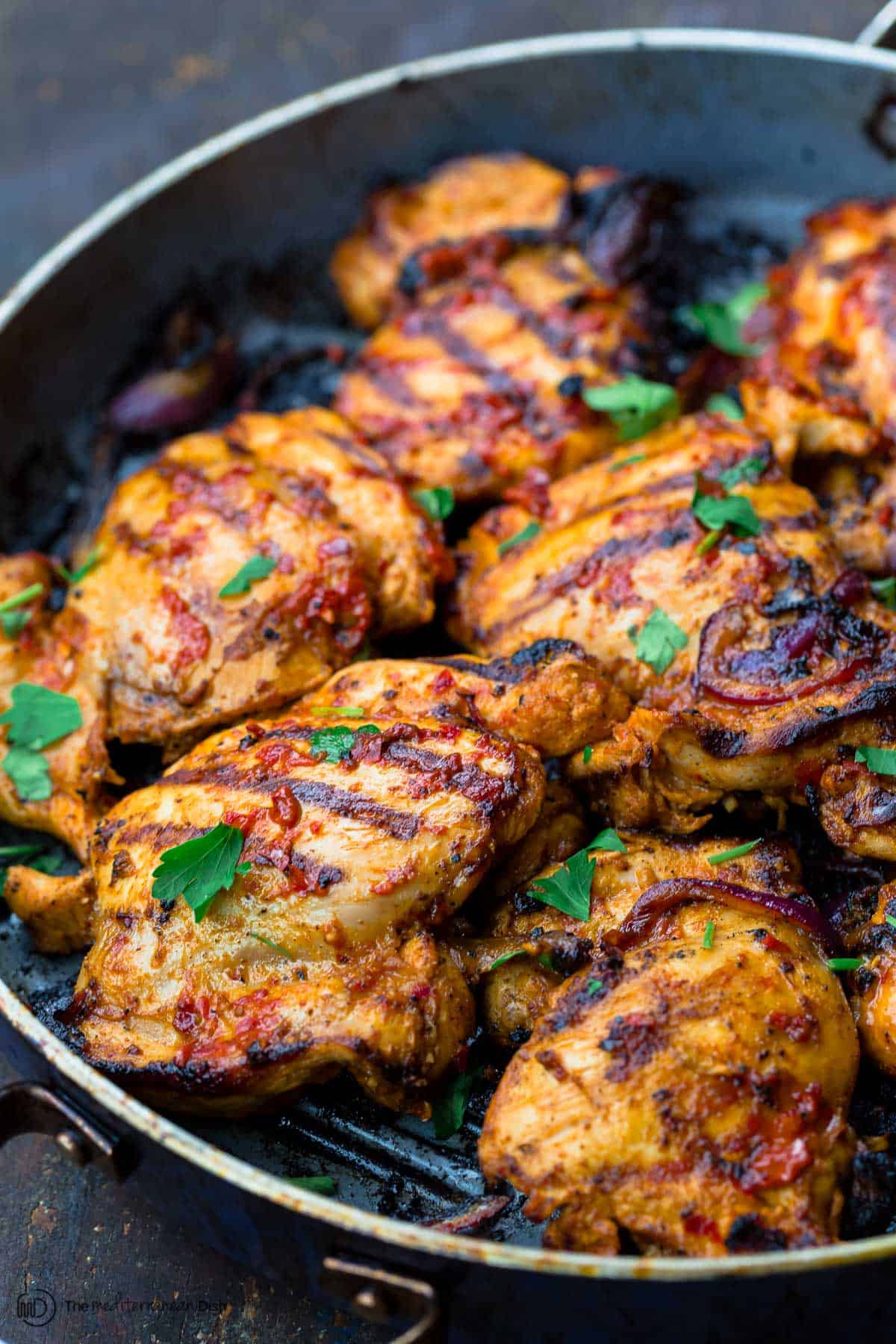 grilled harissa chicken in a pan