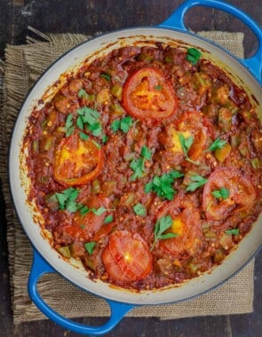 okra and tomatoes in skillet, garnished with parsley