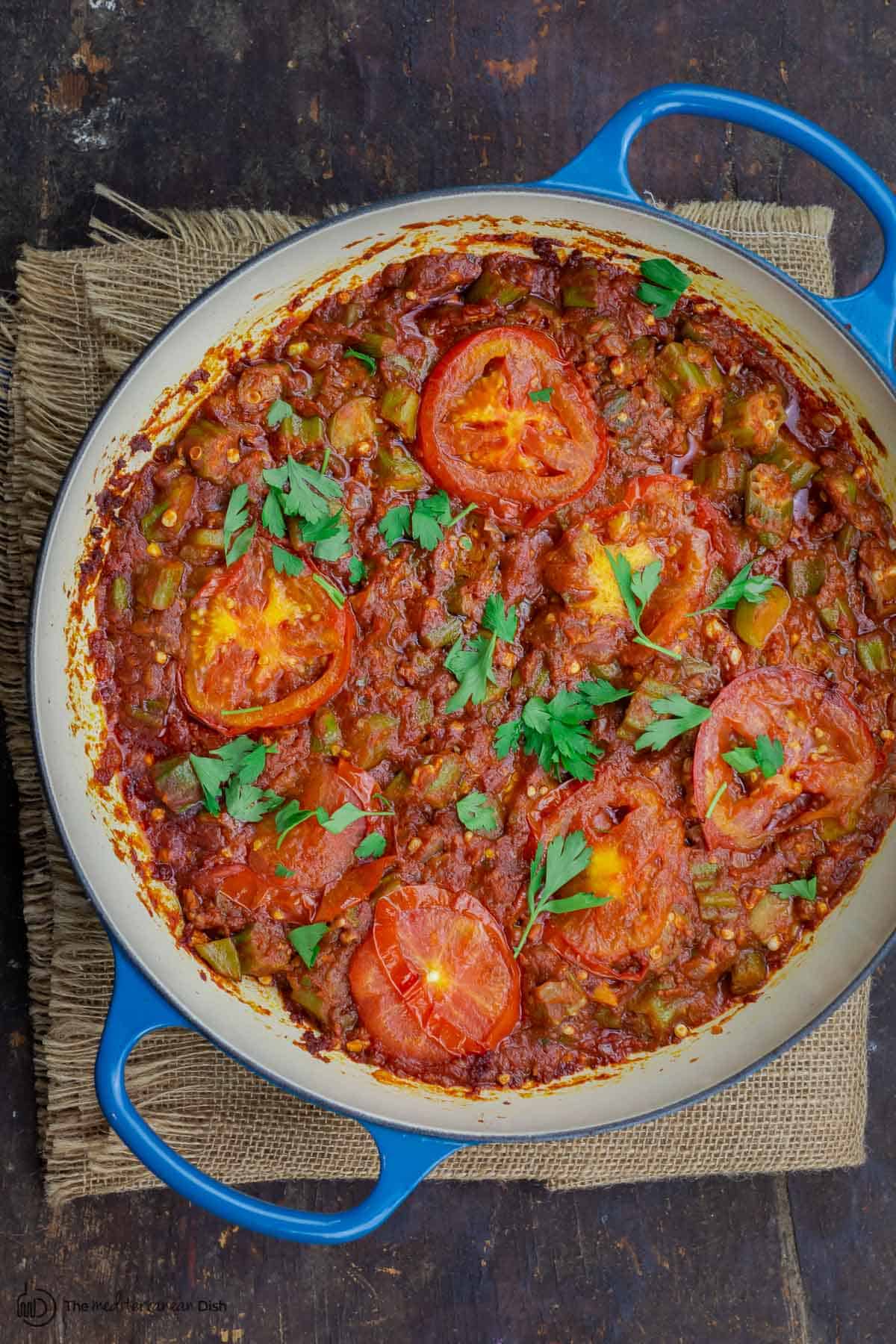 okra and tomatoes in skillet, garnished with parsley