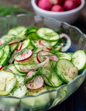 cucumber salad in a bowl. A side bowl of radish