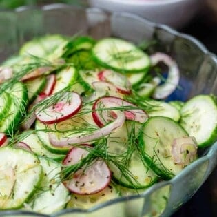 cucumber salad in a bowl. A side bowl of radish